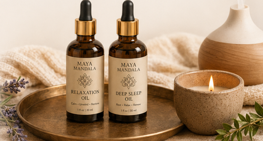 Maya Mandala relaxation and deep sleep oils beside a lit candle and diffuser